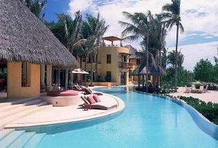 Pool next to beach with views of Pacific Ocean.