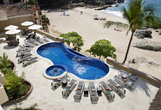 Large heated infinity pool overlooking beach below.