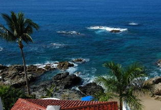 View of secluded beach  and rocks below