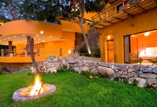 Lawn and fire pit outside living area.