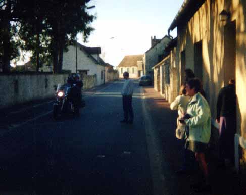 picture of yves and vera riding away on their harley