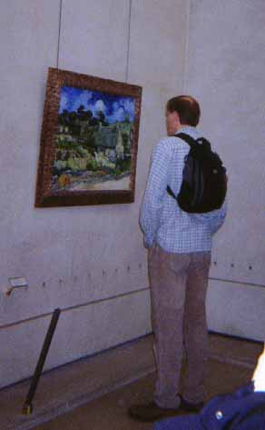 picture of guillaume looking at a painting by van gogh